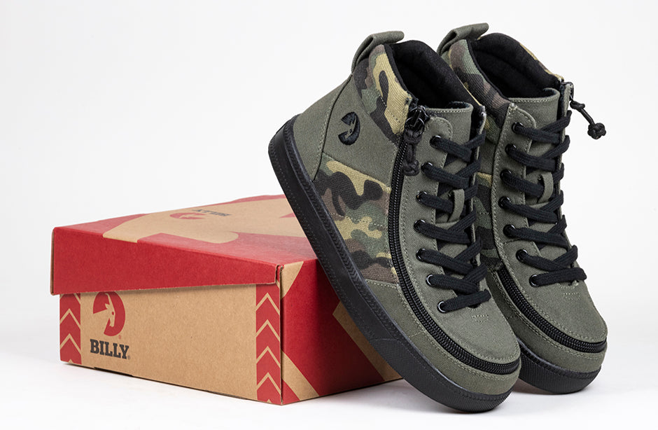 Kid's Olive Camo BILLY Street High Tops, zipper shoes, like velcro, that are adaptive, accessible, inclusive and use universal design to accommodate an afo. BILLY Footwear comes in medium and wide width, M, D and EEE, are comfortable, and come in toddler, kids, mens, and womens sizing.